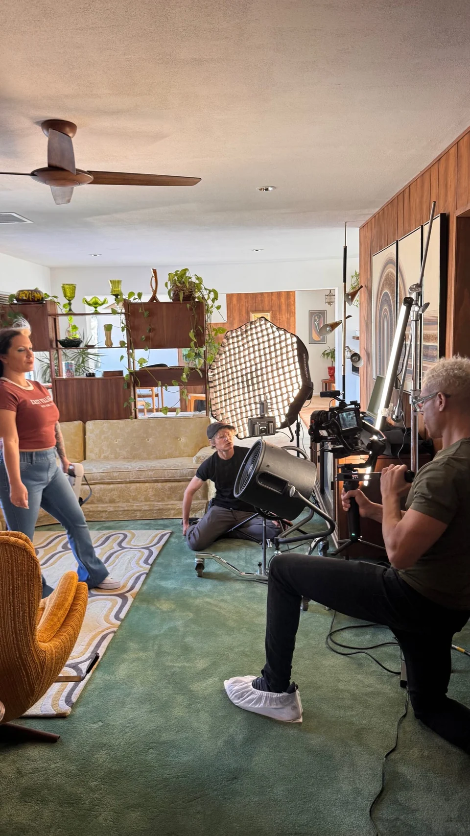 People working with a camera and lighting equipment on a production set.