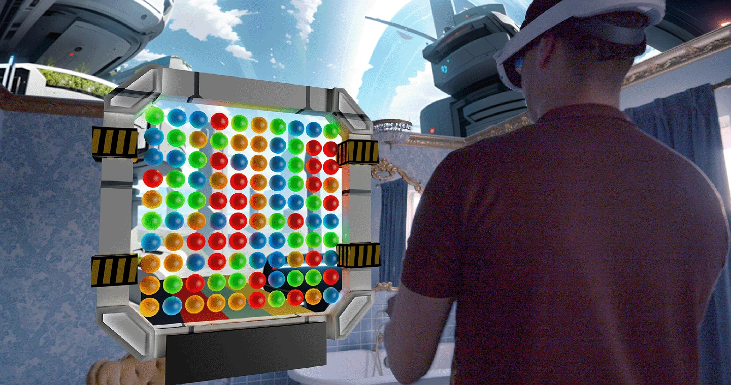 A headset player beside the Balls To The Wall marble puzzle.